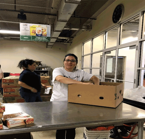 volunteers packing food in boxes