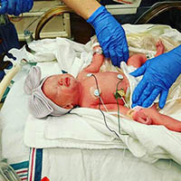 newborn baby in nurses hands